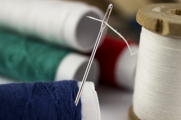 thread wound in a needle with coils of colored threads