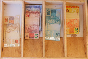 drawer with Brazilian money notes.