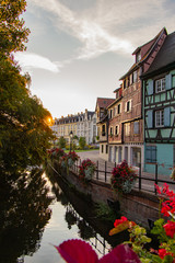 Sunrise in the old town of Colmar, Alsace, France on a sunny day. water canal and traditional half...