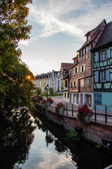 Sunrise in the old town of Colmar, Alsace, France on a sunny day. water canal and traditional half...