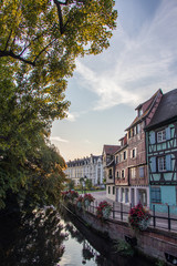 Obraz premium Sunrise in the old town of Colmar, Alsace, France on a sunny day. water canal and traditional half timbered houses. Also known as Petit Venice.