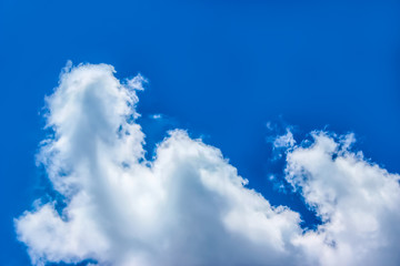 background texture of a blue summer sky with a large white cloud