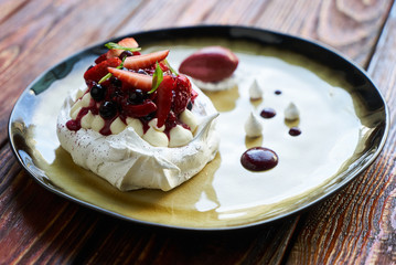 Pavlova Cake with Whipped Cream, Raspberry Jam and Assorted Fruit and Berries, sweet dessert pavlova