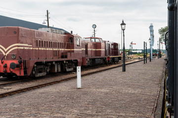 Fototapeta premium Vintage diesel train on urbex shunting platform, authentic industrial details and craftsmanship along the rail way and train station