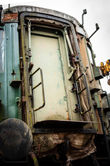 Vintage rusted and decayed carriage exterior on urbex shunting platform, authentic industrial details and craftsmanship along the rail way and station