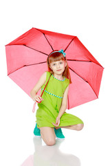 The girl closed from the sun and rain under a red umbrella.