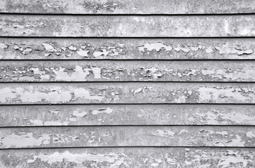 Rusty vintage wall. Rough black and white texture on an former blue surface. Weathered wooden planks.
