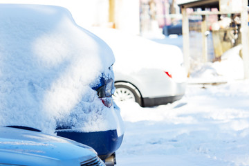 Car under the snow in the city