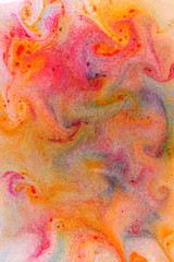 Fluid art. Abstract colorful background. Multicolored stains on liquid. Multicolored pattern with paints on liquid. Blurred background. Minimalism