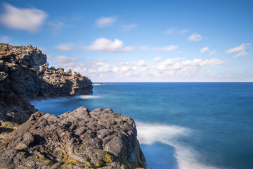 Fototapeta na wymiar rocky coastal seascape with blue sea and skies
