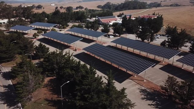 Solar panels over parking lot aerial 4k