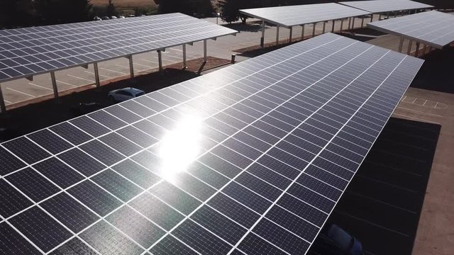 Solar panels over parking lot aerial 4k