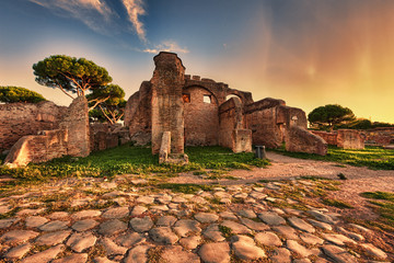Sunset glimpse from cobblestones street in  Ancient Ostia ruins  - Rome