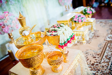 Thai wedding accessory for cultural wedding ceremony, luxury chair for bride and groom, golden tray with pedestal and the others. image for wedding objects, copy space and article.