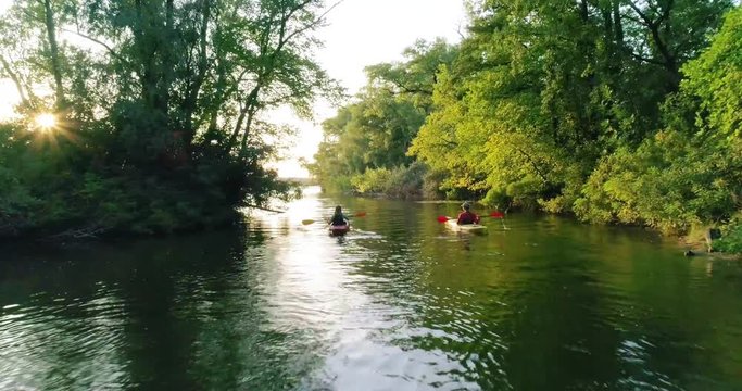 Two kayaks with people on the scenic river