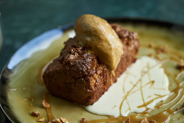 Chocolate dessert fondant with a liquid and pistachio ice cream, close-up