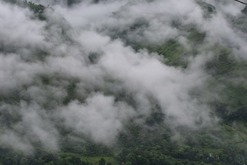 lush green mountains with clouds
