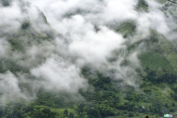 lush green mountains with clouds