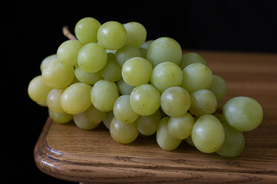 Green Grapes On Wooden Table