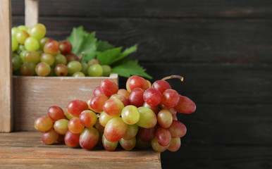 Fresh ripe juicy grapes on table against blurred background with space for text