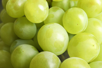 Fototapeta na wymiar Bunch of green fresh ripe juicy grapes as background, closeup
