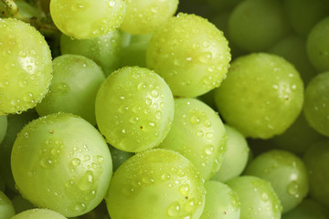 Bunch of green fresh ripe juicy grapes as background, closeup