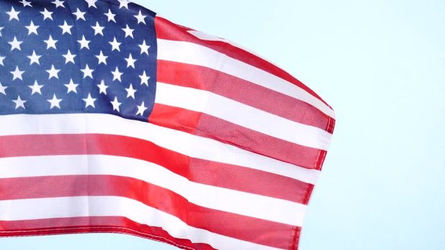 Close up of USA united states of america flag waving on wind. National landmark concept