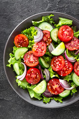 Salad. Fresh vegetable salad with tomato, cucumber, lettuce and red onion