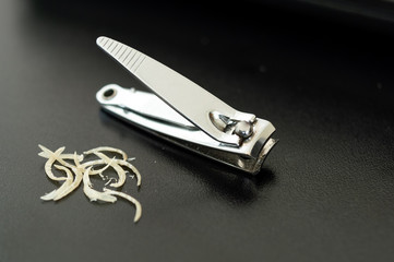 Nail clipper beside some recently cut nails