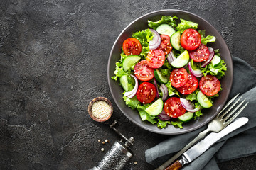 Salad. Fresh vegetable salad with tomato, cucumber, lettuce and red onion