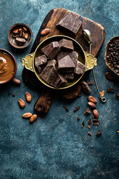 Dark chocolate pieces crushed and cocoa beans. Chocolate background