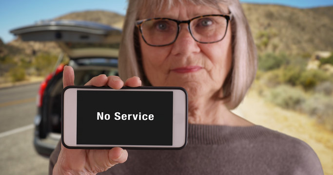 Somber Looking Old Woman Pulled Over On Desert Road With No Service On Phone