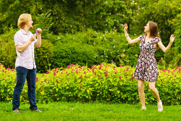 Couple blowing bubbles outdoor