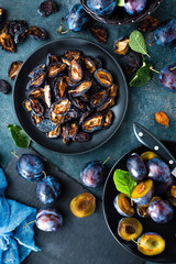 Dried prune and fresh plums with leaves