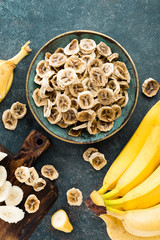 Dried banana chips and fresh bananas