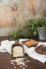 Raw Oatmeal in Wood Scoop; Coconut Brown Sugar and Mini Chocolate Chips in Wood Bowls; Wood Table