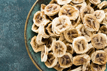Dried banana chips and fresh bananas