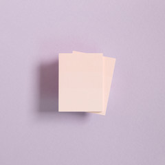 Pink memo pad, sticky notes on purple background