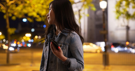 Close up of happy millennial on vacation in Paris France using smartphone