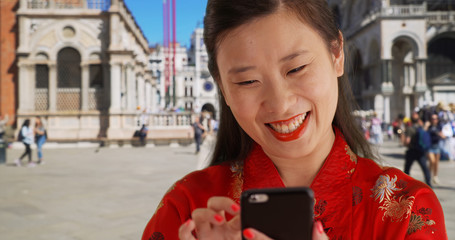 Close up of happy millennial woman taking selfie with smartphone in Venice Italy