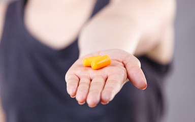 Woman holding protective earplugs