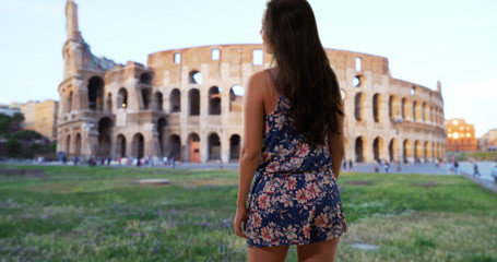 Beautiful slender millennial wearing floral pattern romper in Rome Italy