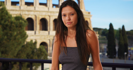 Obraz na płótnie Canvas Beautiful Caucasian girl vacationing in Rome standing near the Coliseum