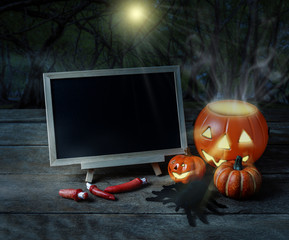 Halloween background. Spooky pumpkin, Black spider, chalkboard on wooden floor with moon and dark forest. Halloween design with copyspace