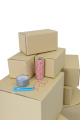 Boxes in different sizes stacked boxes, Adhesive tape, rope and Cutter isolated on white background