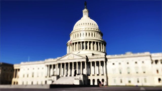 United States Capitol Building in Washington DC in scenic morning time lapse under bright blue sky
