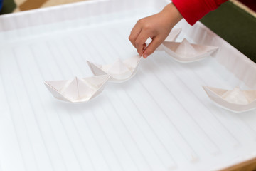 children playing on a paper boat
