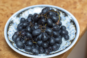 black grapes on a plate
