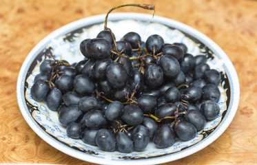 black grapes on a plate