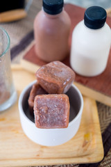 Chocolate ice cubes served with milk and coca bottle